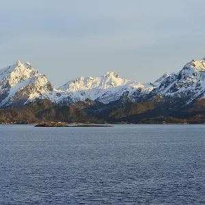 Snow-covered mountains on Hadselfjord in the evening light Snow-covered mountains on Hadselfjord in the evening light