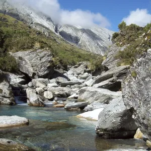 Snow-fed stream runs through the alpine peaks of the Southern Alps
