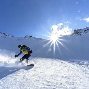 Snowboarder with splitboard rides in the snow