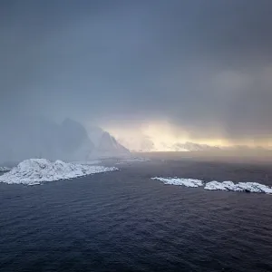 Snowfall over the sea and mountains