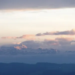 Snowy mountains and clouds at a gentle dusk or dawn Snowy mountains and clouds at a gentle dusk or dawn