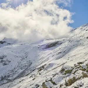Snowy Mountains with clouds at Hochalpenstrasse Snowy Mountains with clouds at Hochalpenstrasse