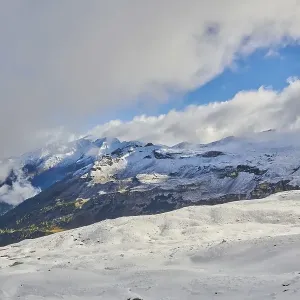 Snowy Mountains with clouds at Hochalpenstrasse Snowy Mountains with clouds at Hochalpenstrasse