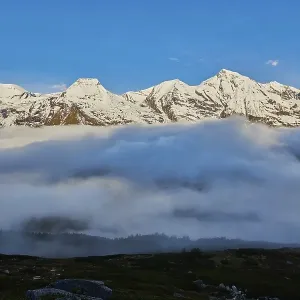 Snowy Mountains above the clouds at Hochalpenstrasse Snowy Mountains above the clouds at Hochalpenstrasse