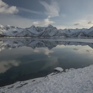 Snowy mountains reflected in the water