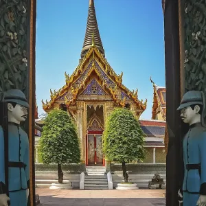 Soldiers sculptures guarding open gates to the Buddhist temple in Bangkok Soldiers sculptures guarding open gates to the Buddhist temple in Bangkok