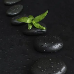 Spa concept with black basalt massage stones arranged chain Spa concept with black basalt massage stones arranged chain