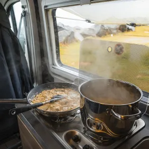 Spaghetti with creamy cream sauce cooked on gas stove in Campervan Spaghetti with creamy cream sauce cooked on gas stove in Campervan