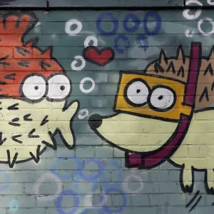 Spiny fish figure kissing a hedgehog figure wearing goggles