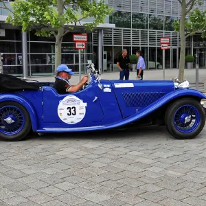 SS1, classic blue convertible at a stylish rally event with a driver