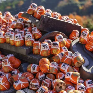 Stacked Daruma dolls with mountain scenery in the background Stacked Daruma dolls with mountain scenery in the background
