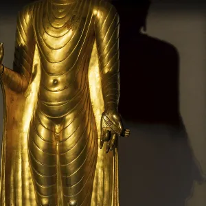 Standing gilded Buddha statue, the right hand (raised) Standing gilded Buddha statue, the right hand (raised)