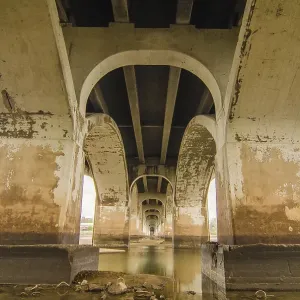 Standing under old bridge over the river Standing under old bridge over the river