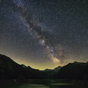 Starry night with the Milky Way over a mountain landscape