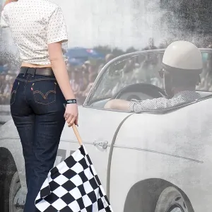 Starter girl standing next to a classic car