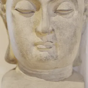 A statue of a face with a serene expression A statue of a face with a serene expression
