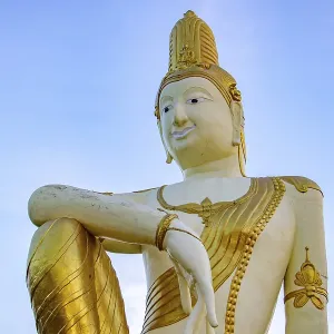 The statue of future Buddha Maitreya on blue background