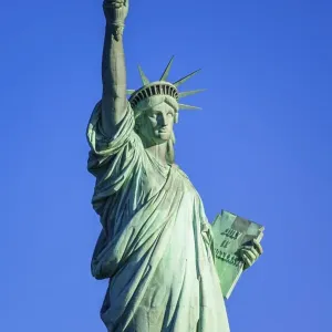Statue of Liberty in front of blue sky Statue of Liberty in front of blue sky