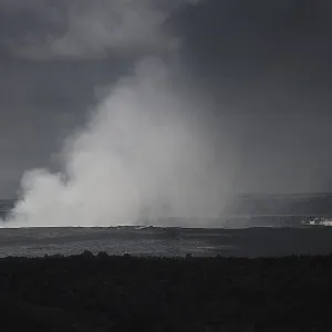 Steaming hole of the kilauea volcano during a cloudy day in black and white