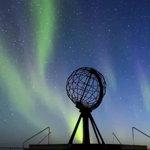 Steel globe at North Cape with northern lights Steel globe at North Cape with northern lights