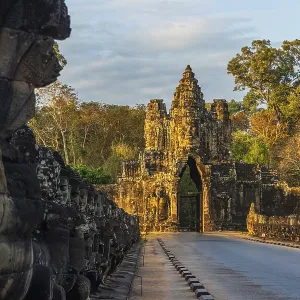 Stone Gate of Angkor Thom in Cambodia illuminated by the setting sun Stone Gate of Angkor Thom in Cambodia illuminated by the setting sun