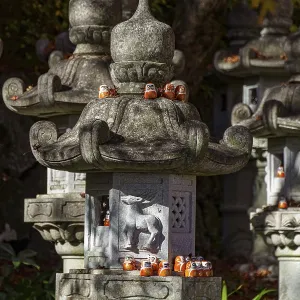 Stone lanterns with small figures in a Japanese garden