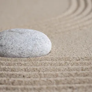 Stone on sand with customizable space for text or message