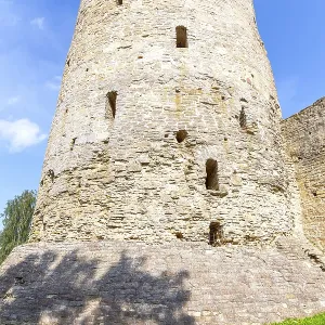 Stone tower of the ancient Izborsk fortress against a blue sky in summer Stone tower of the ancient Izborsk fortress against a blue sky in summer