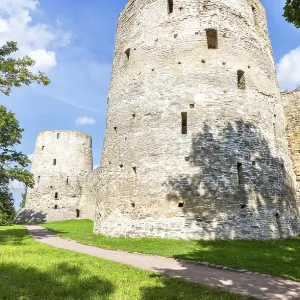 Stone tower of the ancient Izborsk fortress against a blue sky in summer Stone tower of the ancient Izborsk fortress against a blue sky in summer
