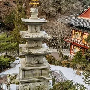 Four story stone carved pagoda on plinth of three elephants at Buddhist temple in South Korea Four story stone carved pagoda on plinth of three elephants at Buddhist temple in South Korea