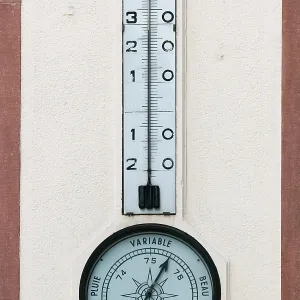 STRASBOURG, FRANCE/EUROPE - JULY 17 : Temperature gauge and barometer on a wall in Strasbourg on July 17