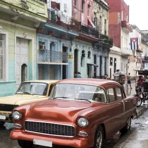 Street scene with old car on rainy day in Havana