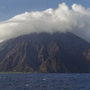 Stromboli volcano and island with bizarre cloudscape Stromboli volcano and island with bizarre cloudscape
