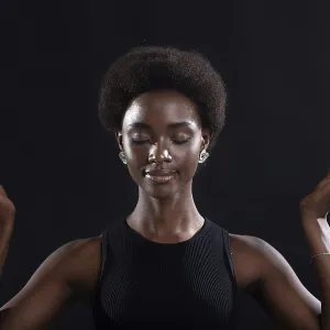 Studio portrait of african american female model showing zen yoga mudra or okay sign gesture Studio portrait of african american female model showing zen yoga mudra or okay sign gesture