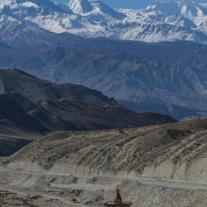 Stupa in a desert landscape before the Annapurna mountain range Stupa in a desert landscape before the Annapurna mountain range
