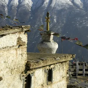 Stupa and prayer flags, Gompa Monastery in front of snowy mountain slope
