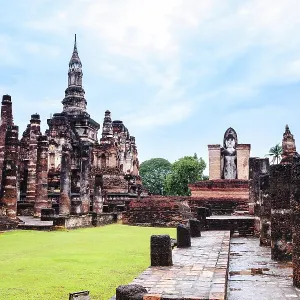 Sukhothai style chedi and standing buddha image in sukhothai historical park