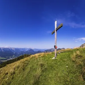 Summit cross on the Einberg with a view of the Lammertal and Tennengebirge mountains