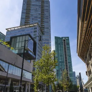 Sunlight illuminating modern skyscrapers and street view in downtown vancouver