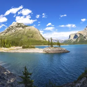 Sunlight illuminating the turquoise waters of lake minnewanka