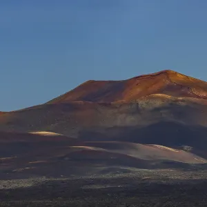 Sunrise in the Fire Mountains, volcanic landscape in Timanfaya National Park Sunrise in the Fire Mountains, volcanic landscape in Timanfaya National Park