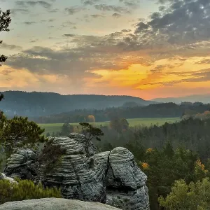 Sunrise in the mountains with a rocky peak in the foreground Sunrise in the mountains with a rocky peak in the foreground