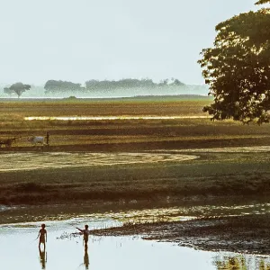 Sunset, fishing children and ploughing farmer at a lake Sunset, fishing children and ploughing farmer at a lake