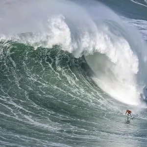 A surfer rides a crashing wave A surfer rides a crashing wave