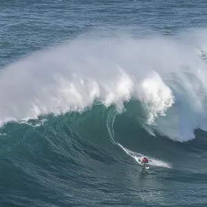 A surfer rides a crashing wave A surfer rides a crashing wave
