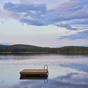 Swimming island in Sweden on a lake at sunset Swimming island in Sweden on a lake at sunset
