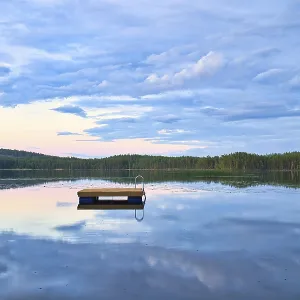 Swimming island in Sweden on a lake at sunset Swimming island in Sweden on a lake at sunset