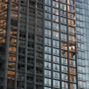 Tall glass building reflecting the CN Tower and a blue sky with a grid pattern in Toronto Tall glass building reflecting the CN Tower and a blue sky with a grid pattern in Toronto