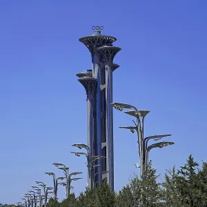 Tall Olympic tower in modern architecture surrounded by trees and clear sky Tall Olympic tower in modern architecture surrounded by trees and clear sky
