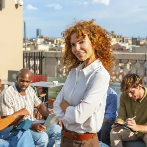 Team of diverse professionals working together on a city rooftop